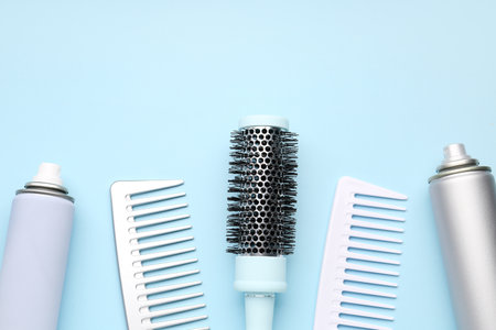 Hair brushes with spray bottles on blue backgroundの写真素材