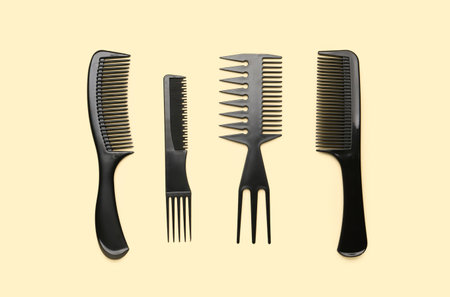 Hairdresser's brushes on beige backgroundの写真素材