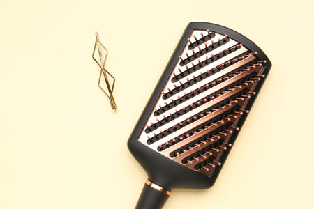 Hairpin with brush on beige background, closeupの写真素材