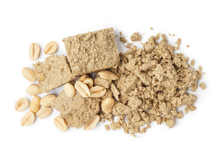 Crushed halva and peanuts on white background