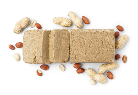Sweet halva with peanuts on white background
