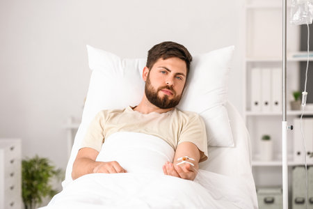 young man in hospital roomの写真素材