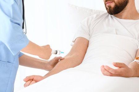 Female doctor working with patient in hospital roomの写真素材