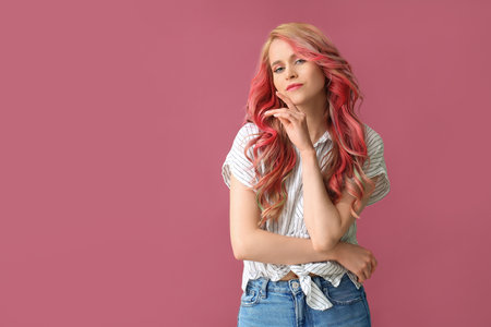 Beautiful young woman with unusual hair on color backgroundの写真素材