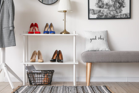Stylish interior of modern hall with shoes on stand and benchの写真素材