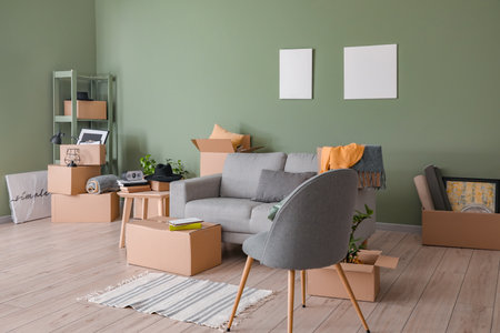 Cardboard boxes with accessories in new flat on moving dayの写真素材