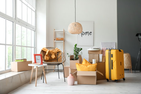 Cardboard boxes with accessories in new flat on moving dayの写真素材