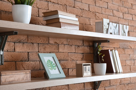 Shelves with decor on brick wallの写真素材