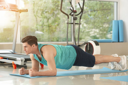 Sporty young man training in gym
