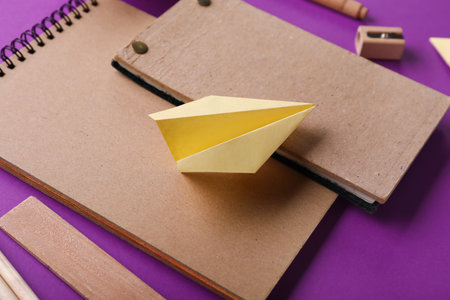 Composition with stationery supplies and paper planes on purple backgroundの写真素材