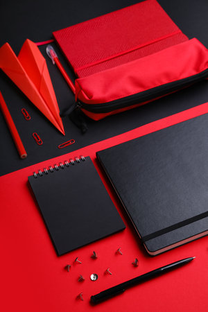 Composition with, notebooks stationery supplies and paper plane on color backgroundの写真素材