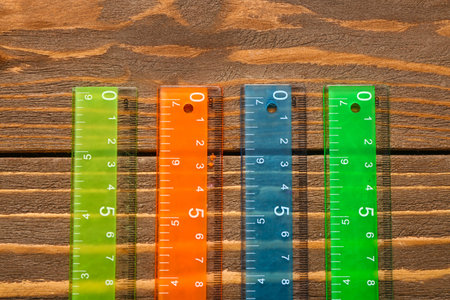 Colorful plastic rulers on wooden backgroundの写真素材
