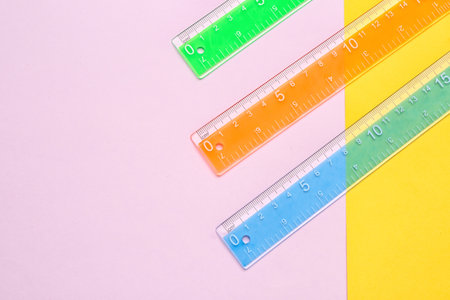 Colorful plastic rulers on color backgroundの写真素材