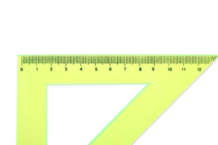 Yellow triangle plastic ruler on white background