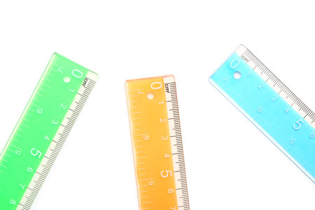 Colorful plastic rulers on white background