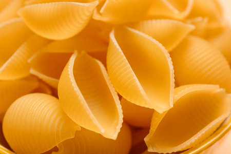 Raw conchiglie pasta as background, closeupの写真素材