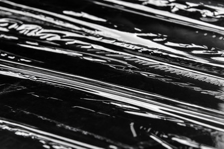 Plastic stretch wrap on black backgroundの写真素材