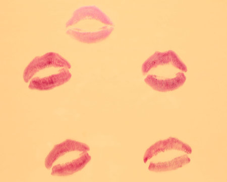 Lipstick kiss marks on gray background