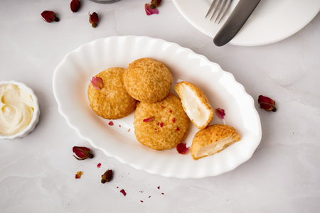 Plate with tasty choux dessert on light backgroundの写真素材