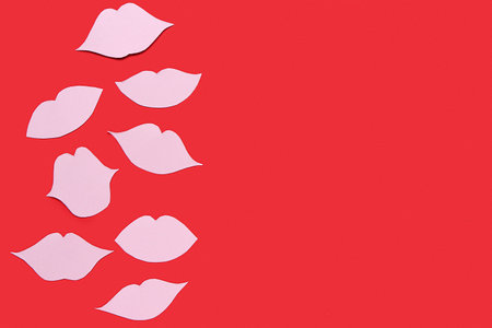 Pink paper lips on red backgroundの写真素材
