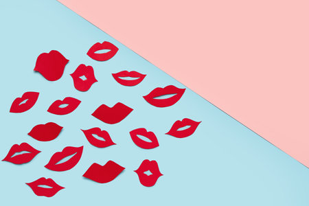 Red paper lips on color backgroundの写真素材