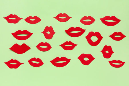 Red paper lips on green backgroundの写真素材