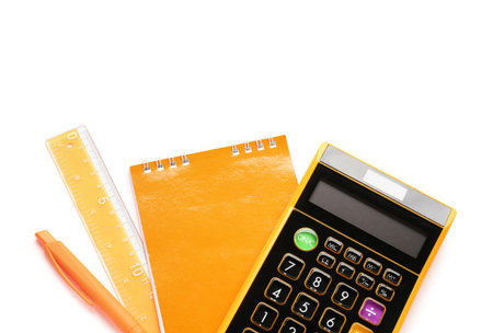 Calculator, notepad and ruler on white background