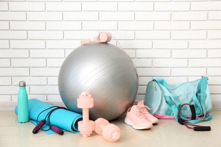 Sports equipment with bag near white brick wallの写真素材