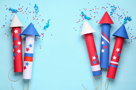 Firework rockets, confetti and serpentine for Independence Day on blue backgroundの写真素材
