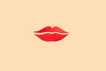 Red paper lips on beige backgroundの写真素材