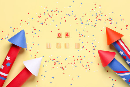 Firework rockets, serpentine, confetti and numbers 04 for Independence Day on beige background