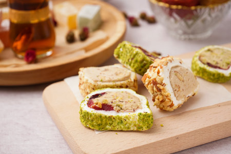 Wooden board with tasty Turkish Delight on light background, closeupの写真素材
