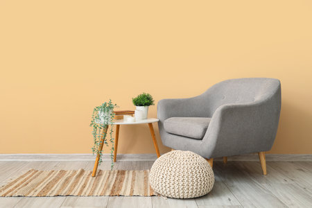 Interior of living room with armchair and artificial plants on tableの写真素材