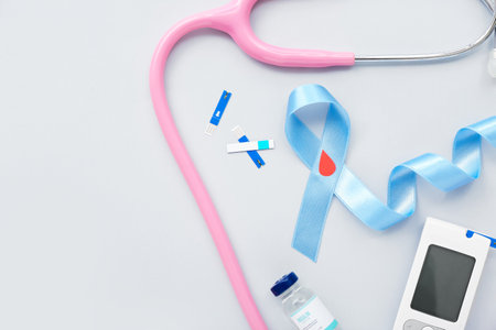 Awareness ribbon with glucometer, insulin and stethoscope on light background. Diabetes conceptの写真素材