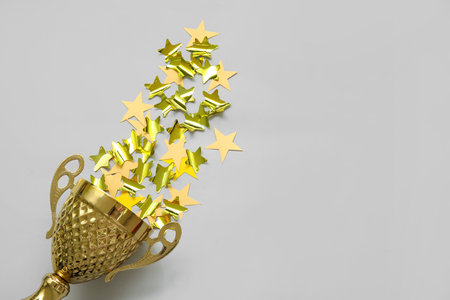 Gold cup with stars on gray backgroundの写真素材