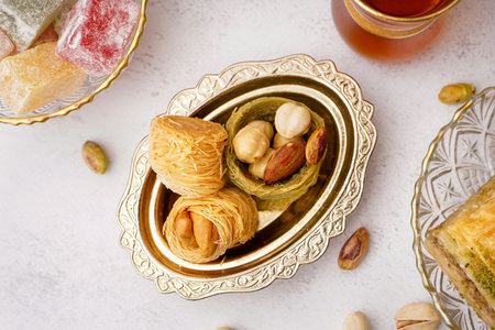 Bowl with tasty baklava on light background