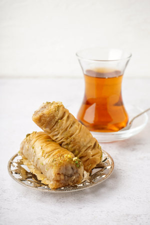 Plate with tasty baklava on light backgroundの写真素材