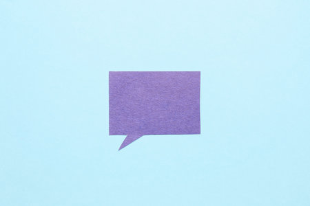 Blank paper speech bubble on blue backgroundの写真素材