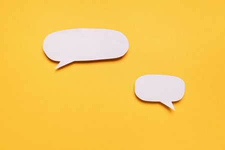 Blank paper speech bubbles on orange backgroundの写真素材