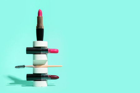 Podium with lipsticks and brush on mint backgroundの写真素材