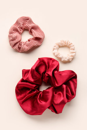 Set of stylish silk scrunchies on light backgroundの写真素材