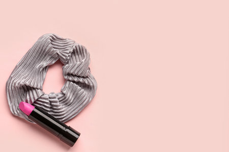 Stylish scrunchy and lipstick on pink backgroundの写真素材