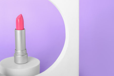 Decorative plaster podiums and lipstick on lilac backgroundの写真素材