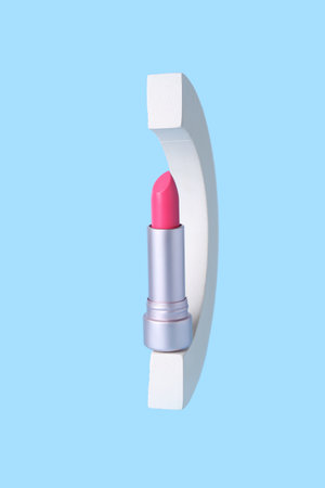 Decorative plaster podium and lipstick on blue backgroundの写真素材