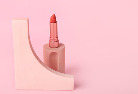 Decorative plaster podiums and lipstick on pink backgroundの写真素材