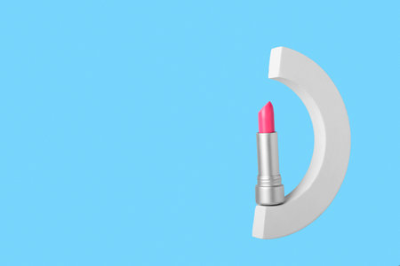 Decorative plaster podium and lipstick on blue backgroundの写真素材