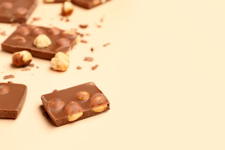 Sweet tasty chocolate with nuts on beige backgroundの写真素材
