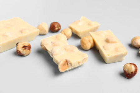 Sweet white chocolate with nuts on light backgroundの写真素材