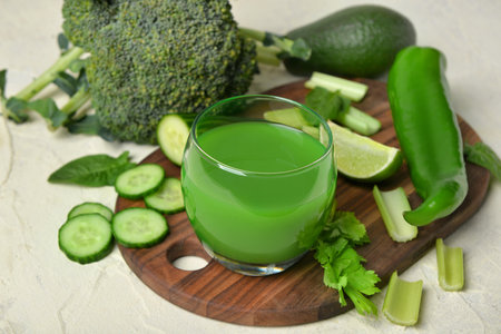 Glass of tasty green juice on grunge backgroundの写真素材