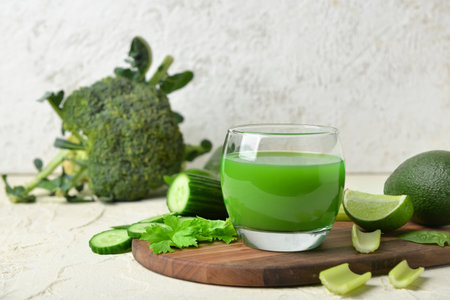 Glass of tasty green juice on grunge tableの写真素材
